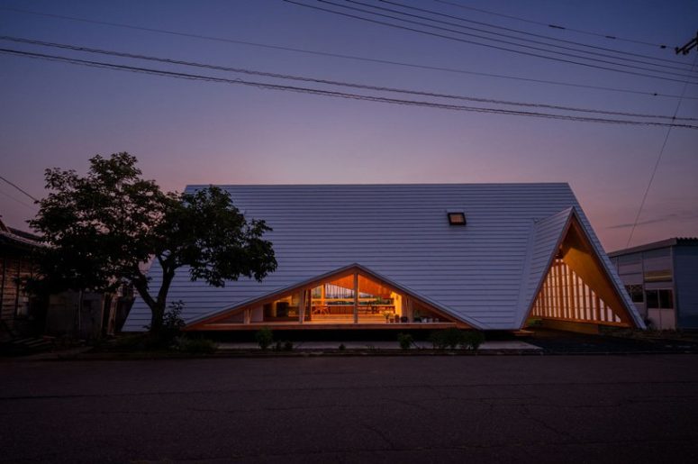 This house is shaped like a tent and is an additional structure to the other buildings on the site creating a whole village