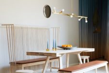 02 The dining space is done with a wooden table and some benches – with a back and no back, there’s a catchy gold chandelier