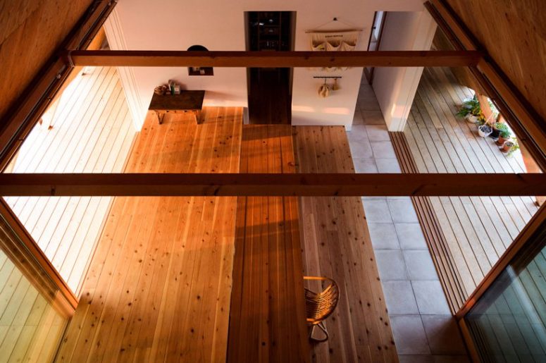 Wooden beams and lots of wooden surfaces make the space more welcoming, and the furniture and decor is tradiitonally minimalist