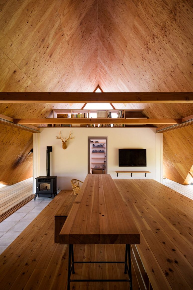 There are two different levels in the home that are connected yet separate with a large wooden shelf There are two different levels in the home that are connected yet separate with a large wooden shelf