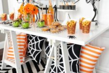 05 a bold Halloween buffet in black, white, orange and green, with spiderwebs and bright blooms