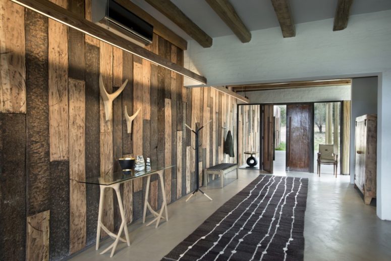 You'll see all shades of relcaimed and regular wood throughout the house and outdoors spaces, and glass and metal, too