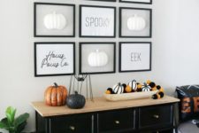 07 a Halloween entryway console with striped and black and orange pumpkins, a gallery wall with pumpkins and words