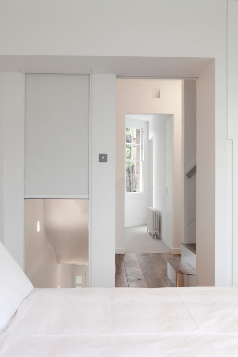The master bedroom is all white, with stained wooden floors to make it catchier a perfect place to have a rest The master bedroom is all-white, with stained wooden floors to make it catchier - a perfect place to have a rest