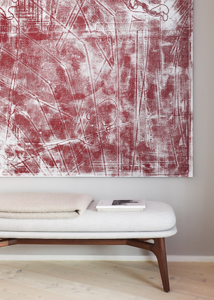 The entryway is catchy with its statement artwork and a chic and comfortable bench, it's super inviting