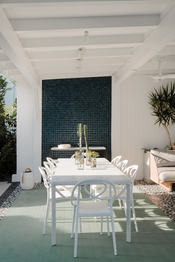 There's an outdoor dining and living space plus cacti and plants