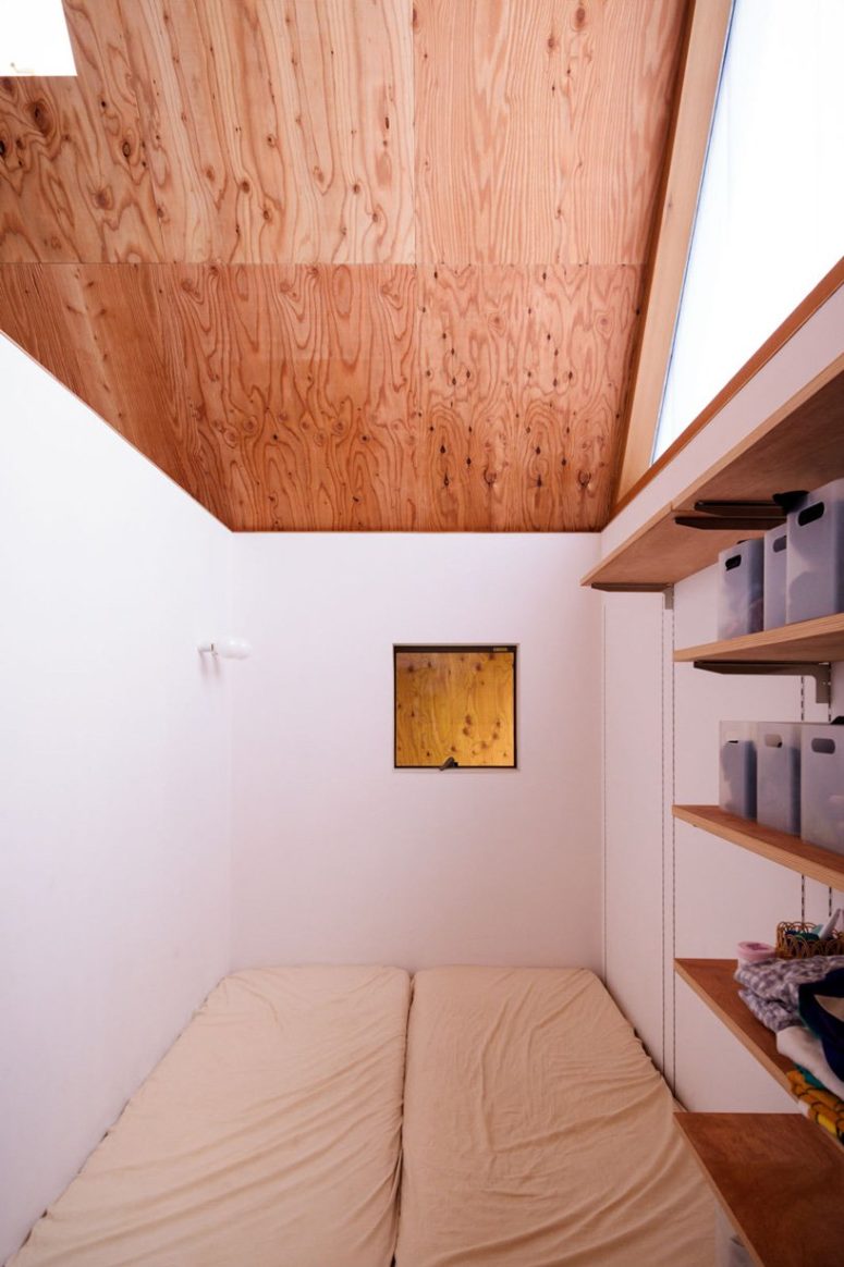 The bedroom is ultra-minimalist, with shelves and just some mattresses on the floor
