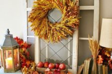 all-natural and rustic fall decor done with fall leaves, wheat, a wheat wreath, apples and pumpkins is just amazing