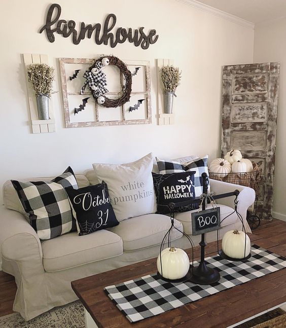 simple coffee table styling with scales with white pumpkins and a sign plus a checked table runner for a farmhouse space