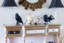 14 a refined entryway console with black lamps, blackbirds, black candleholders, a black house and Halloween trees