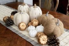21 faux pumpkins of fabric, paper and plastic plus pinecones will give you a cool fall centerpiece
