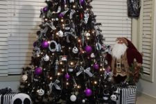 a black Halloween tree decorated with lights, Jack Skellington ornaments, purple ones and some striped bows