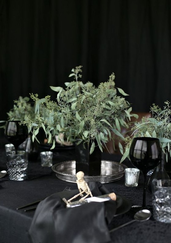 a black square vase with eucalyptus is a stylish minimalist Halloween decoration for your modern party