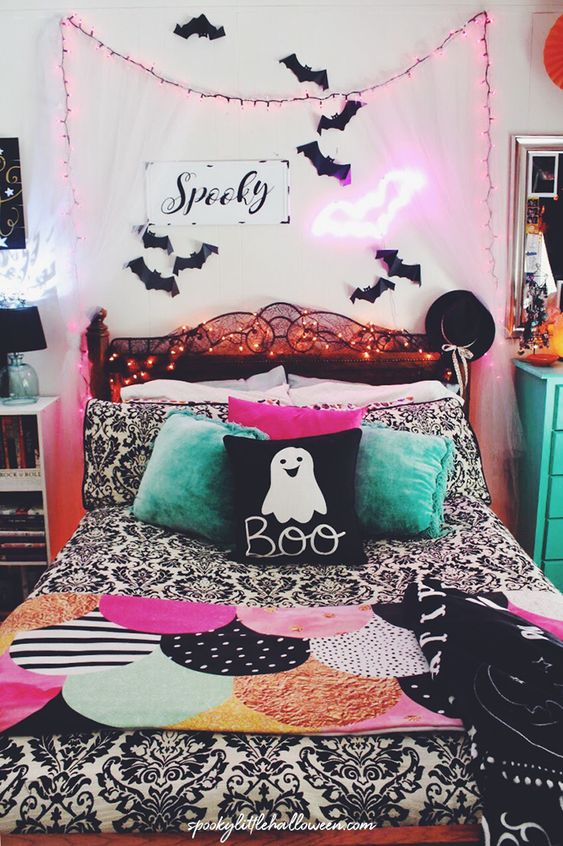 a bright Halloween bedroom done in pink, green, black and white, with bats, neon lights and lots of prints is super fun