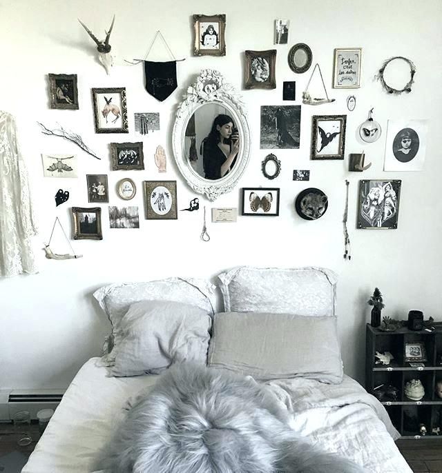 a monochromatic Halloween bedroom with a statement gallery wall that brigns that Halloween feel here