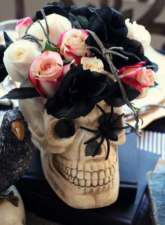 a skull with white, black and pink roses and a spider is a cool and quick to make Halloween centerpiece