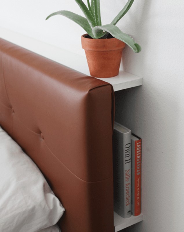 an IKEA Hemnes bed with a headboard that is hacked with some foam and elegant brown leather to make it look chic