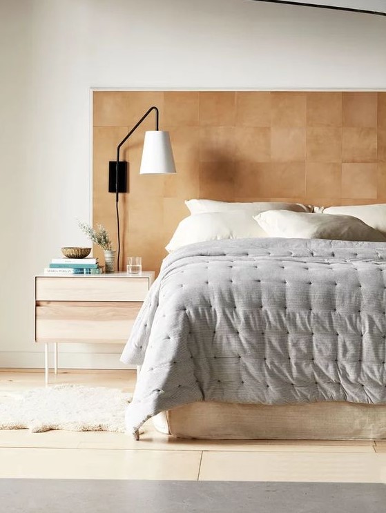 an extended leather headboard like this one will add a warm touch of color and texture to the space