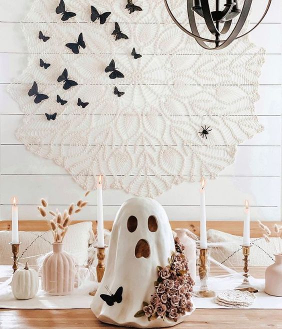 neutral vases with grasses, white pumpkins, a ghost decorated with a butterfly and blooms for Halloween