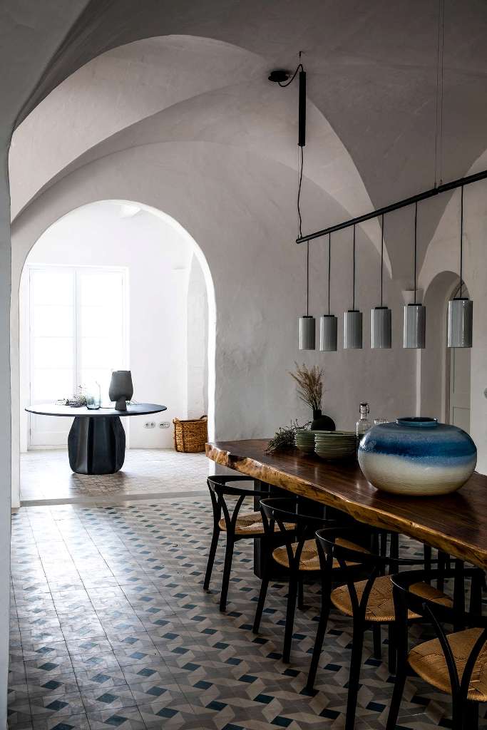 The dining space is done with a wooden table, a range of pendant lamps and a pretty vase, look at the gorgeous tiled floor The dining space is done with a wooden table, a range of pendant lamps and a pretty vase, look at the gorgeous tiled floor