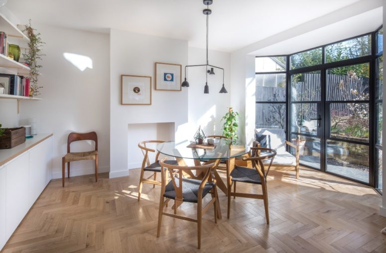 The kitchen and dining space are also filled with light due to a glazed wall, there's stylish furniture and chic lamps The kitchen and dining space are also filled with light due to a glazed wall, there's stylish furniture and chic lamps