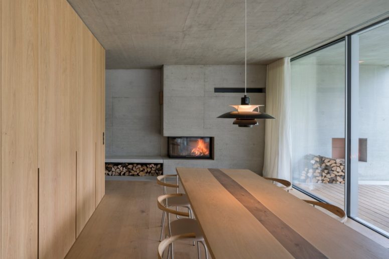 The dining space was done with a fireplace, a firewood storage unit, contemporary furniture and there's an access to the terrace The dining space was done with a fireplace, a firewood storage unit, contemporary furniture and there's an access to the terrace