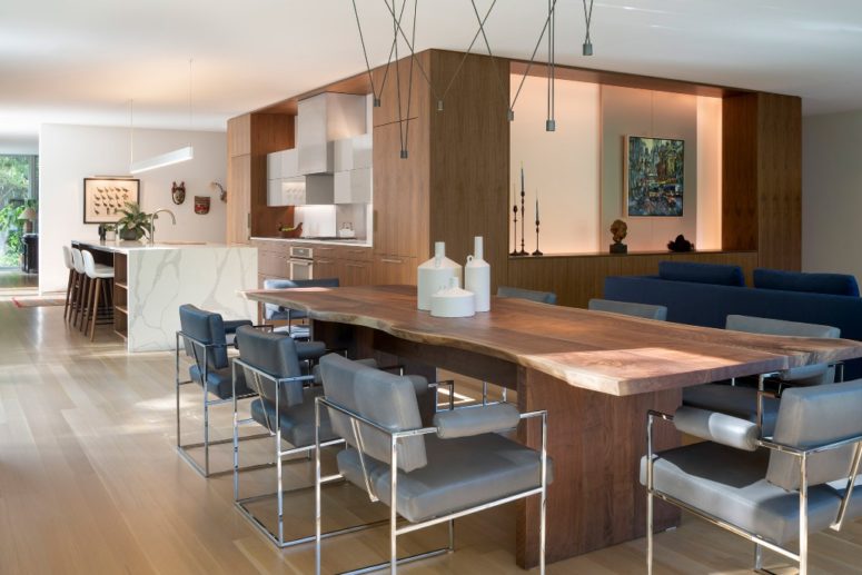a cool way to unite living spaces in one The living, dining rooms and the kitchen are united into one layout and is done with contemporary furniture and lamps