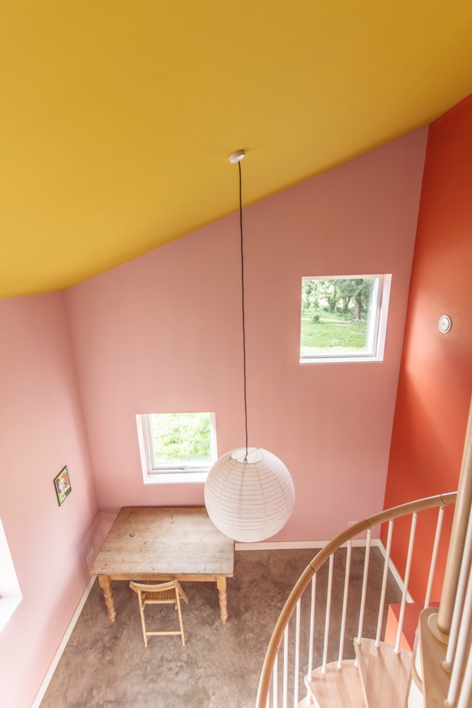 a colorful breakfast nook Here's a small yet colorful breakfast space or home office in bold shades and with simple wooden furniture