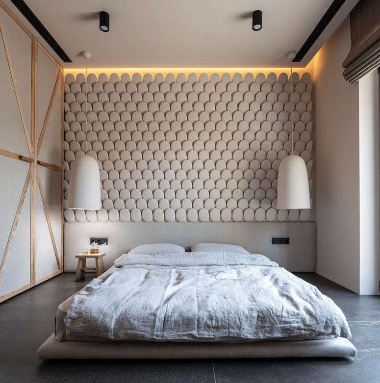 The bedroom is done with a scale statement wall, pendant lamps and a platform bed
