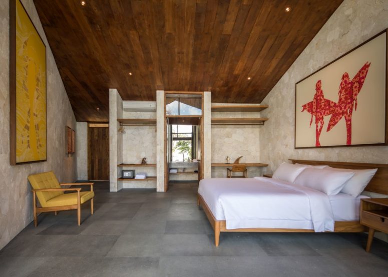 The bedroom is done in neutrals, a rich colored wood ceiling, modenr furniure and open storage space The bedroom is done in neutrals, a rich-colored wood ceiling, modenr furniure and open storage space