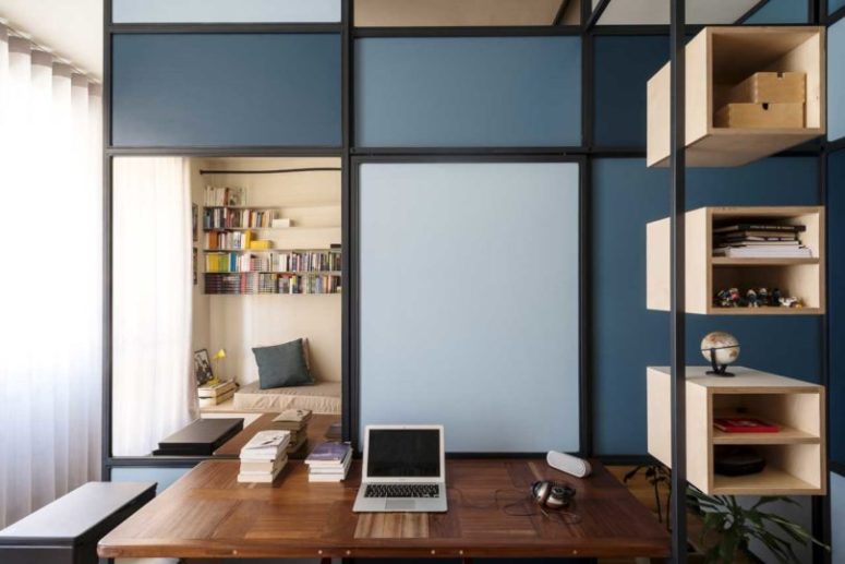 a small home office with a partition wall that separates it
