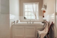 08 The bathroom is done in white, with a vintage tub and beadboards plus white subway tiles to make it cozy and chic