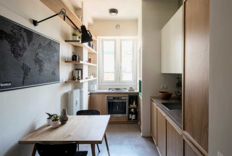 The kitchen is done with large windows to fill it with lights, a glass door and some furniture to have meals there