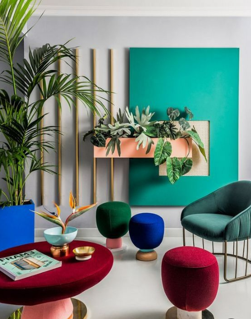 a bold living room done in emerald, forest green, cobalt blue and deep red - jewel tones never go out of style