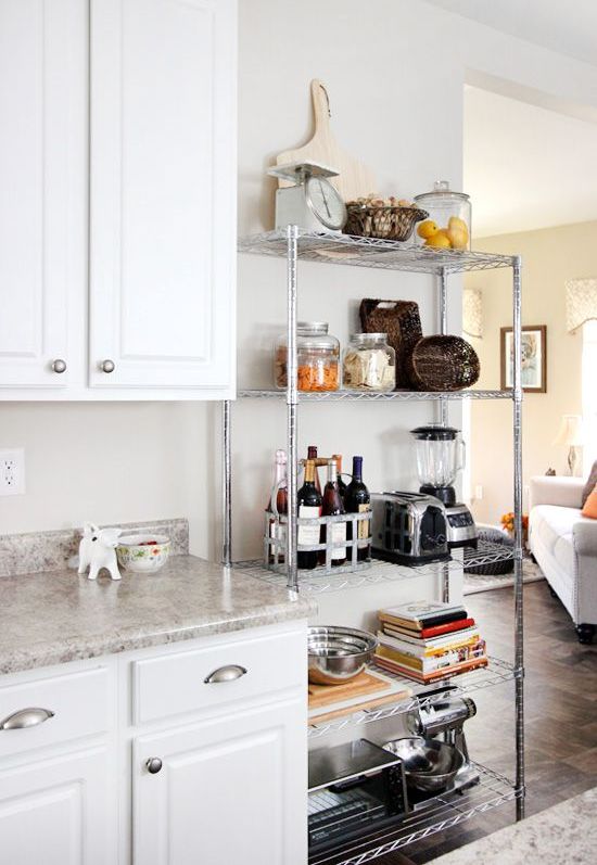 a lightweight metal shelving unit next to your traditional cabinets will give a more industrial feel to the space