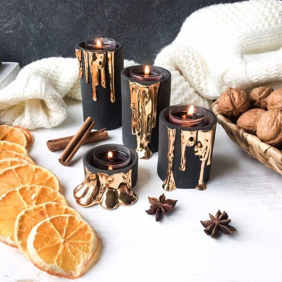 black candleholders with dripping gold will accommodate little tealights and will add elegance to your decor