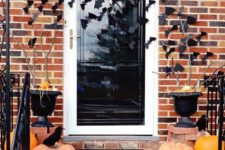 simple and stylish Halloween porch decor with heirloom pumpkins, blackbirds and bats on the walls and door