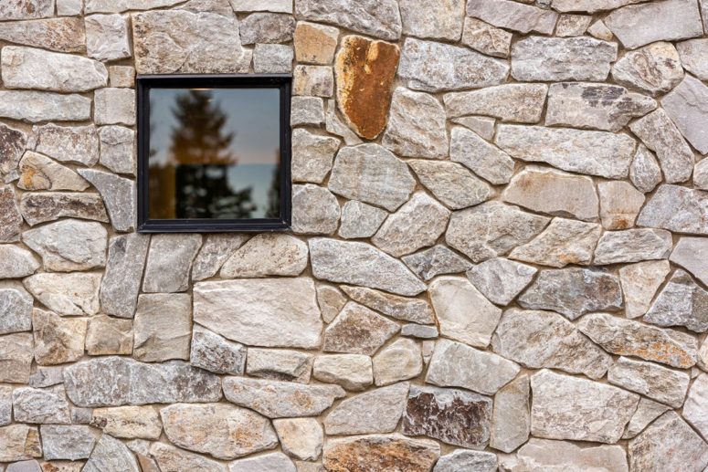 The house is clad with locally-sourced wood and stone, which help it blend with the surroundings