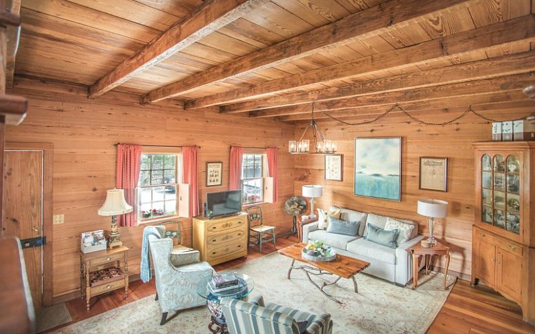 The living room is done with wood completely, there's a range of vintage furniture, a chic chandelier and upholstery in powder blue The living room is done with wood completely, there's a range of vintage furniture, a chic chandelier and upholstery in powder blue