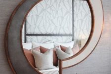 02 a chic sculptural mirror in white and grey, with copper framing is a beautiful decoration that will add light