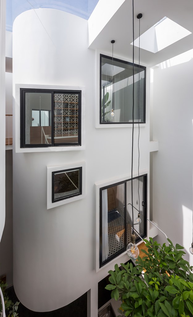 The windows of the living spaces feature the atrium with bulbs hanging down