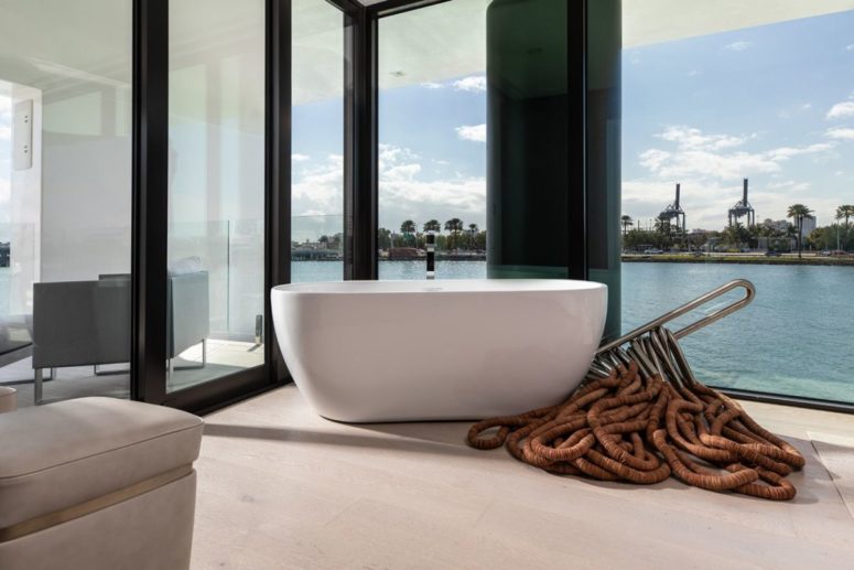 a contemporary minimalist bathroom design with views The bathroom is minimalist, with full views and elegant furniture, it's not very private yet light-filled