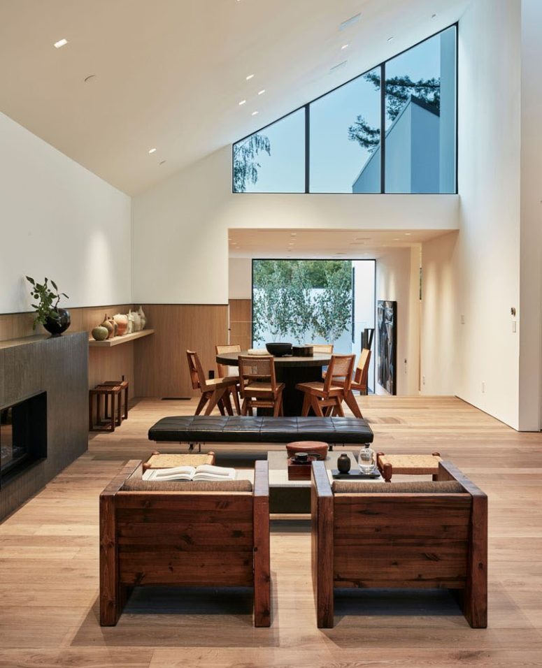 The social area features a dining space by the entrance to the courtyard and a living room with a sleek fireplace The social area features a dining space by the entrance to the courtyard and a living room with a sleek fireplace