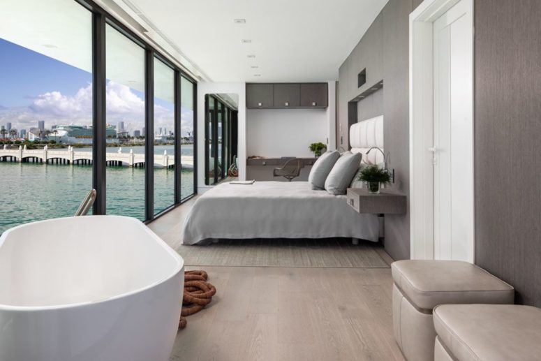 The bedroom is right here, and the home office space, too, with taupe furniture and a chic upholstered bed The bedroom is right here, and the home office space, too, with taupe furniture and a chic upholstered bed