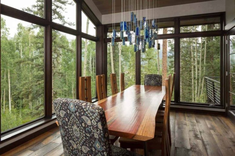 The dining area is amazing. It’s framed by full-height windows on two sides and has a gorgeous live-edge table