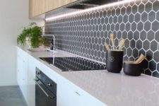 06 a minimalist black backsplash with small hexagon tiles highlighted with white grout