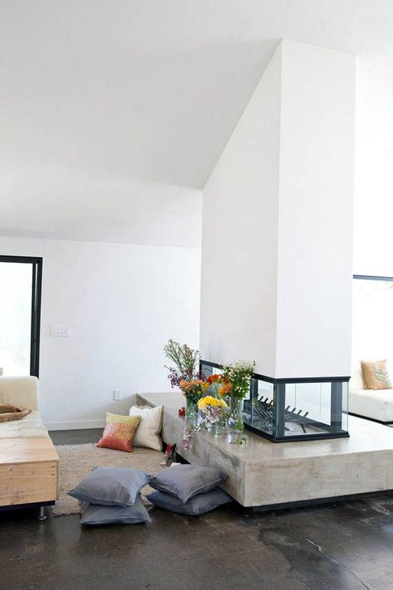 a stylish white double-sided fireplace with a glass part and a concrete one is a chic idea for a contemporary home