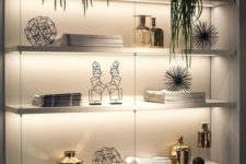 06 a wall shelving unit lit up with built-in lights is a cool idea to make your objects on display at their best
