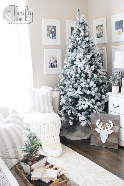 winter farmhouse decor with a flocked Christmas tree, a deer sign, a mini Christmas tree and wooden beads