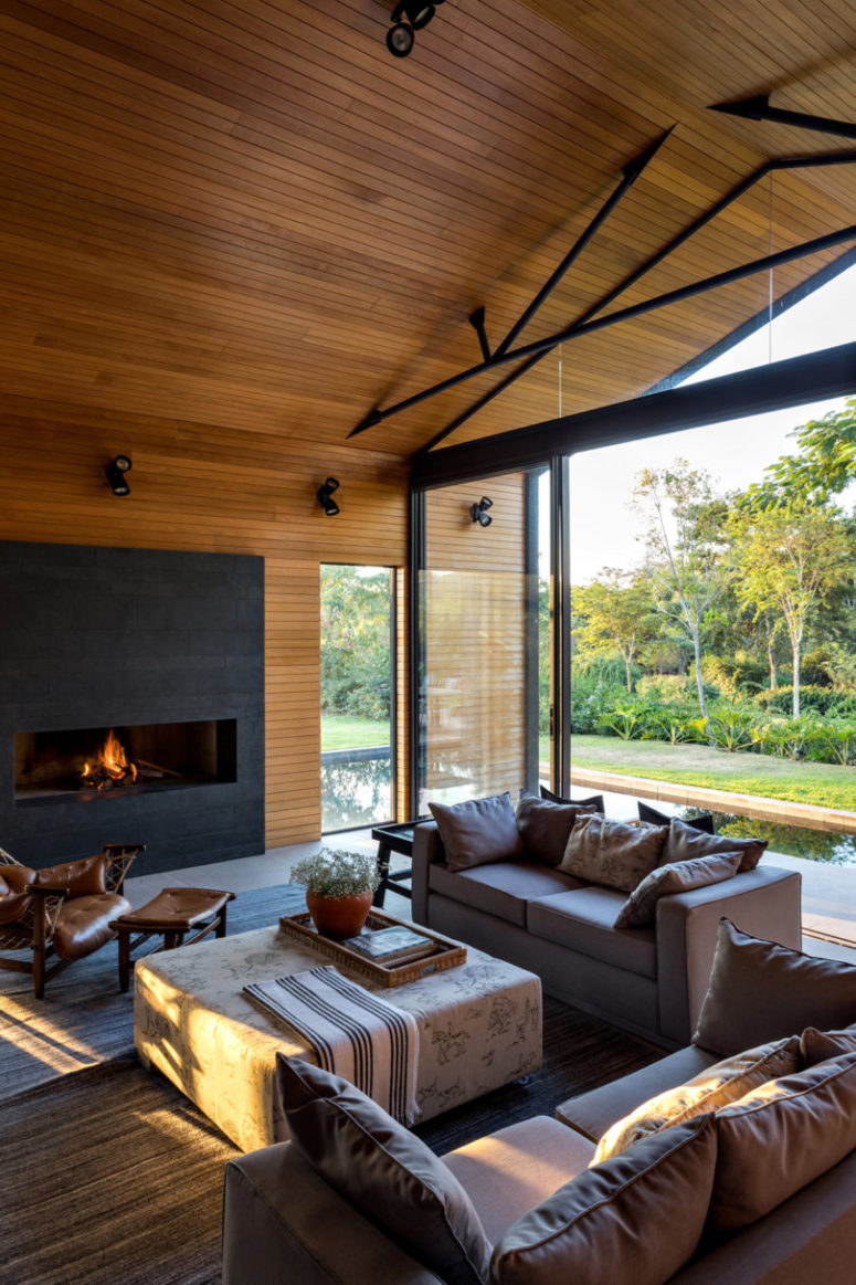 An indoor outdoor space is done with comfortable furniture and there's a modenr fireplace to create an ambience An indoor-outdoor space is done with comfortable furniture and there's a modenr fireplace to create an ambience